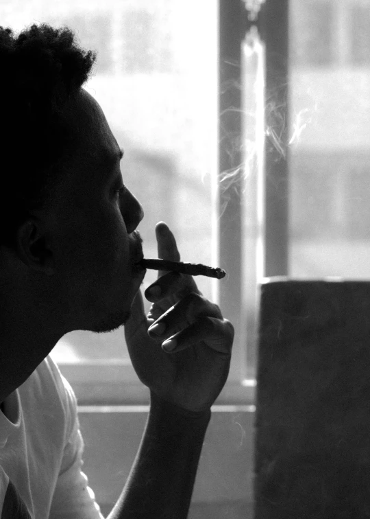 a woman in white shirt smoking a cigarette