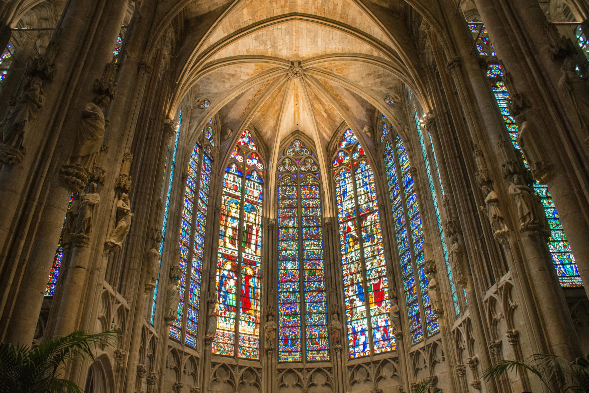 an empty, beautiful cathedral with a lot of colorful stained glass windows