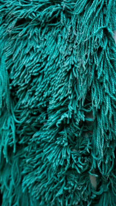 many pieces of green yarn that is partially cut