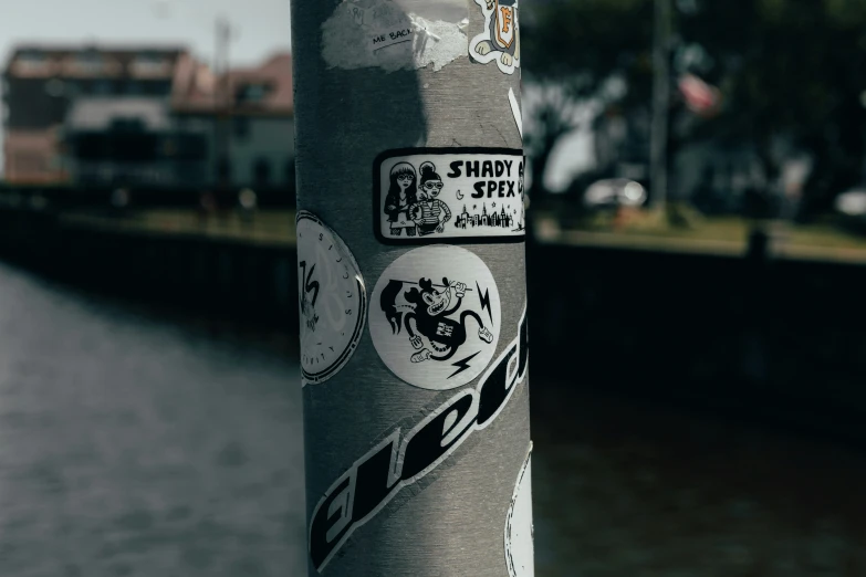 a street pole that has many stickers on it