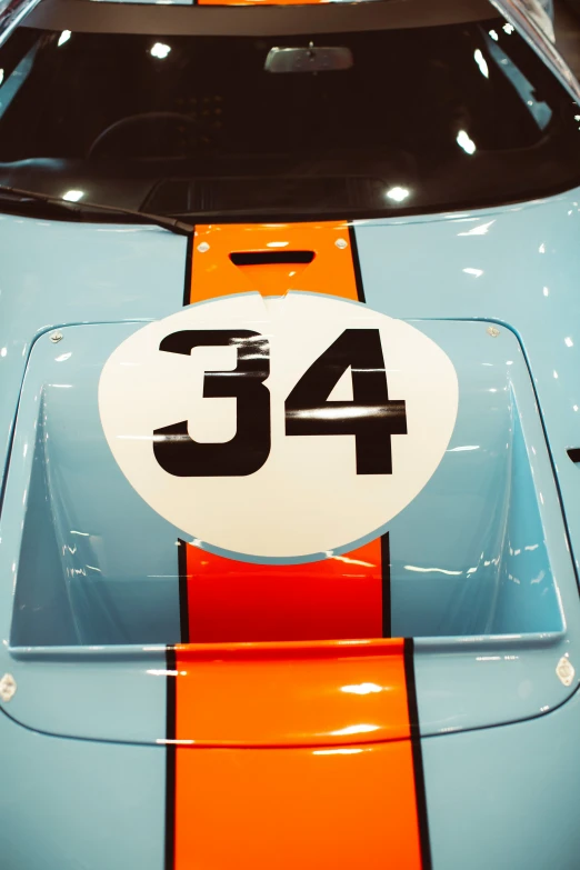 an orange and blue racing car with the number 46