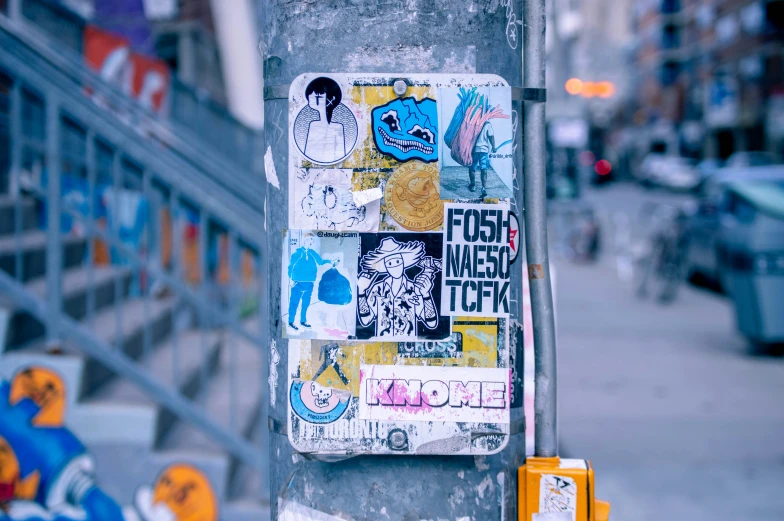the post is covered in street art and stickers