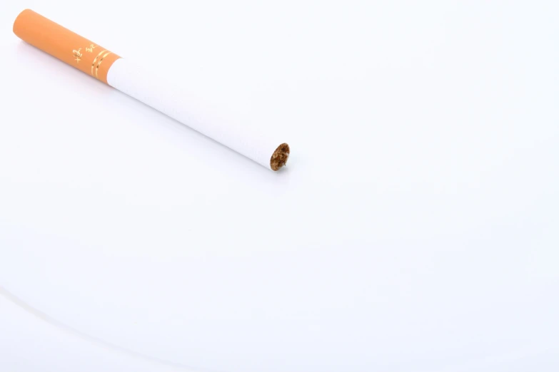 an orange and white cigarette next to it's end