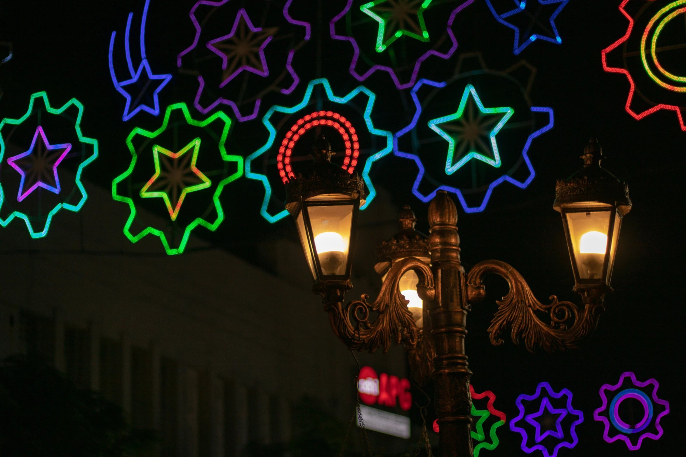 a lit up street light on top of a pole