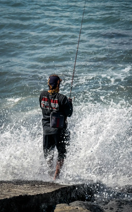 a person in a wet suit is holding a pole