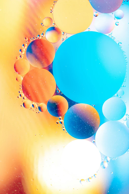 a mixture of colorful bubbles that have blue, yellow, and orange colors