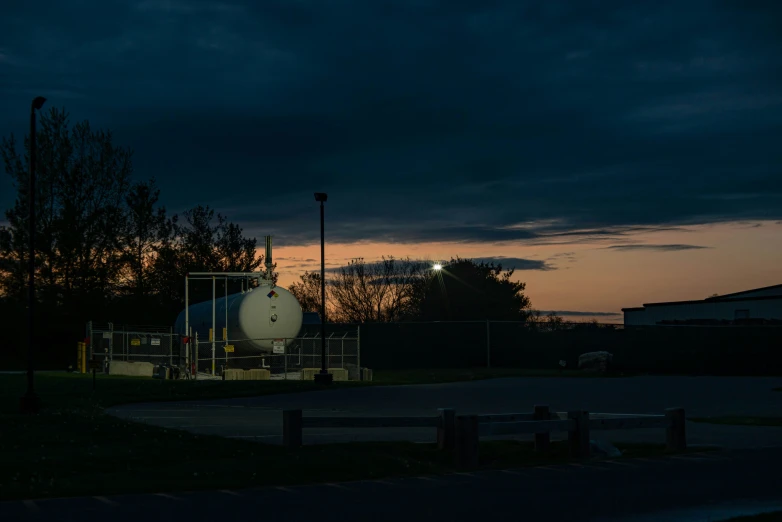 a view of a white tank under a night sky