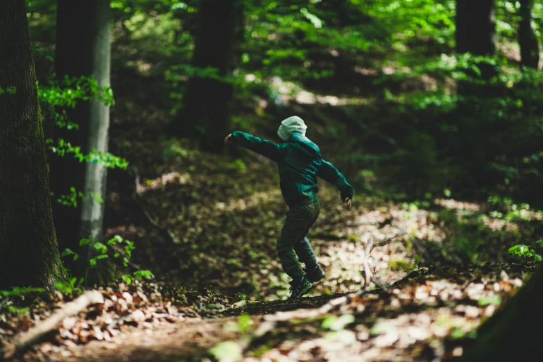 there is a person riding a board in the forest