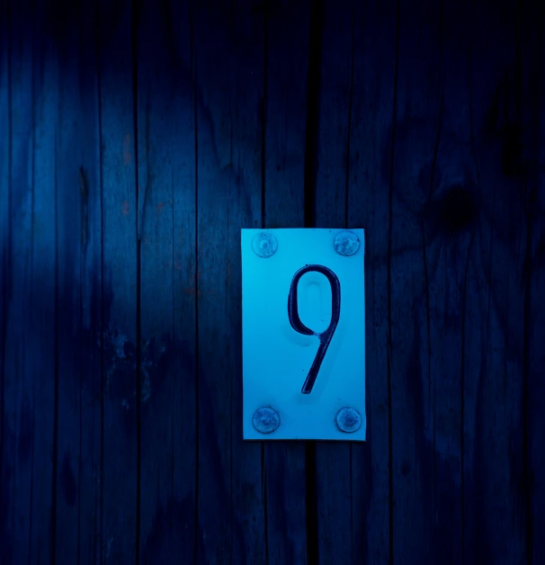 an illuminated blue sign with a number on it