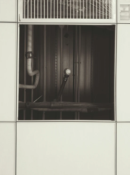 pipes in a room with panels and tiled wall