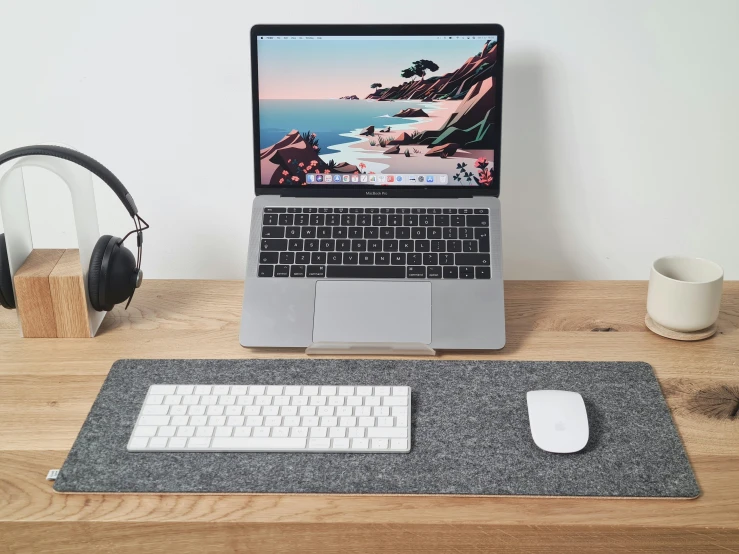 a table with a laptop on it and a headphone