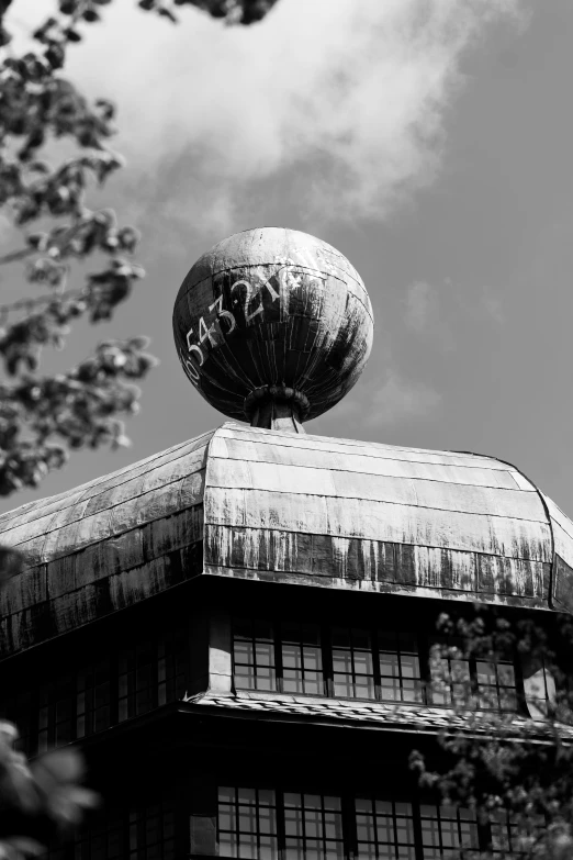 an old building with a strange roof and an object on top