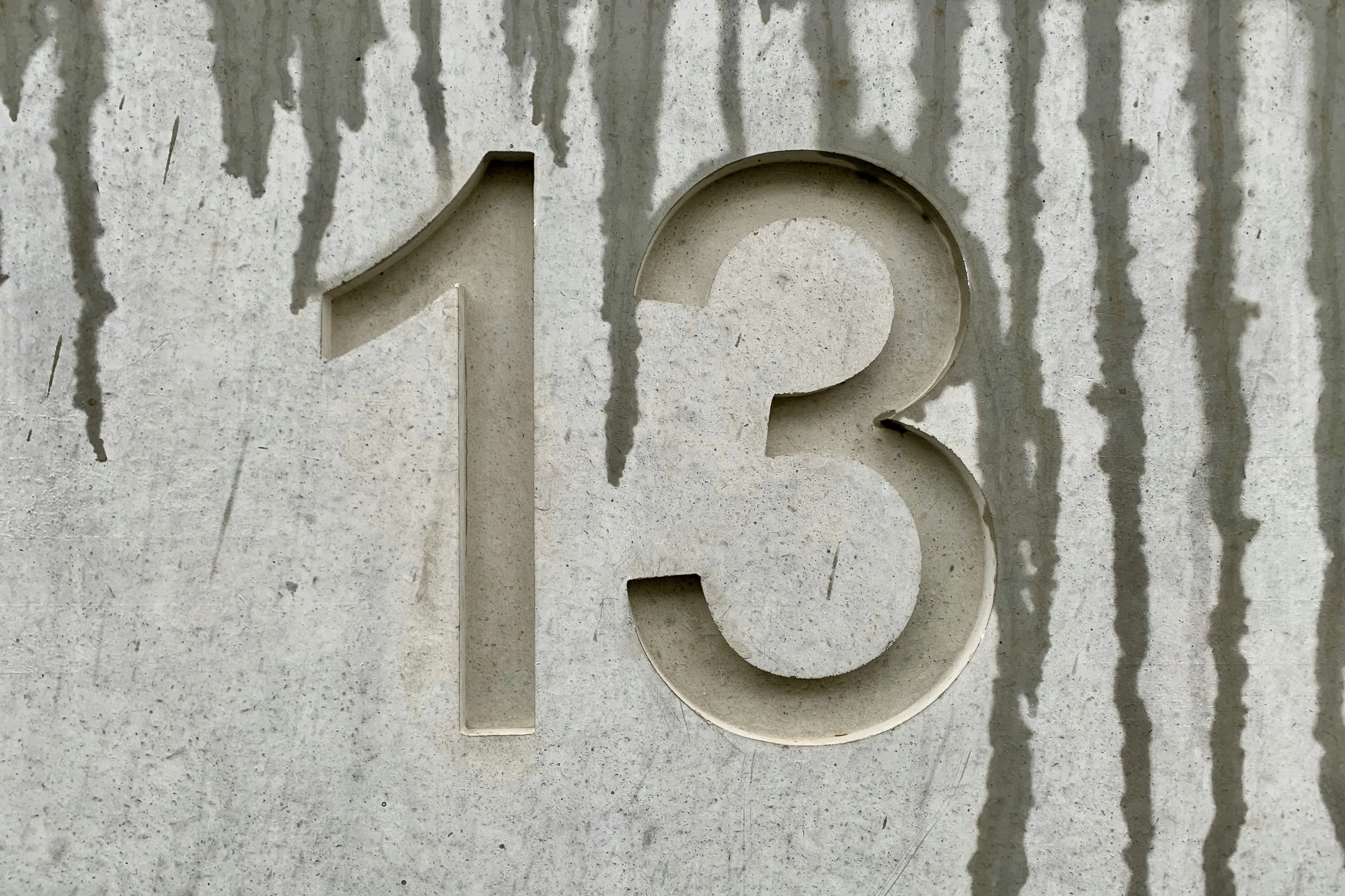 the number thirteen is depicted on the side of a building