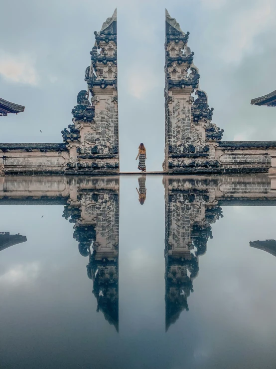 a person stands in front of a very tall building