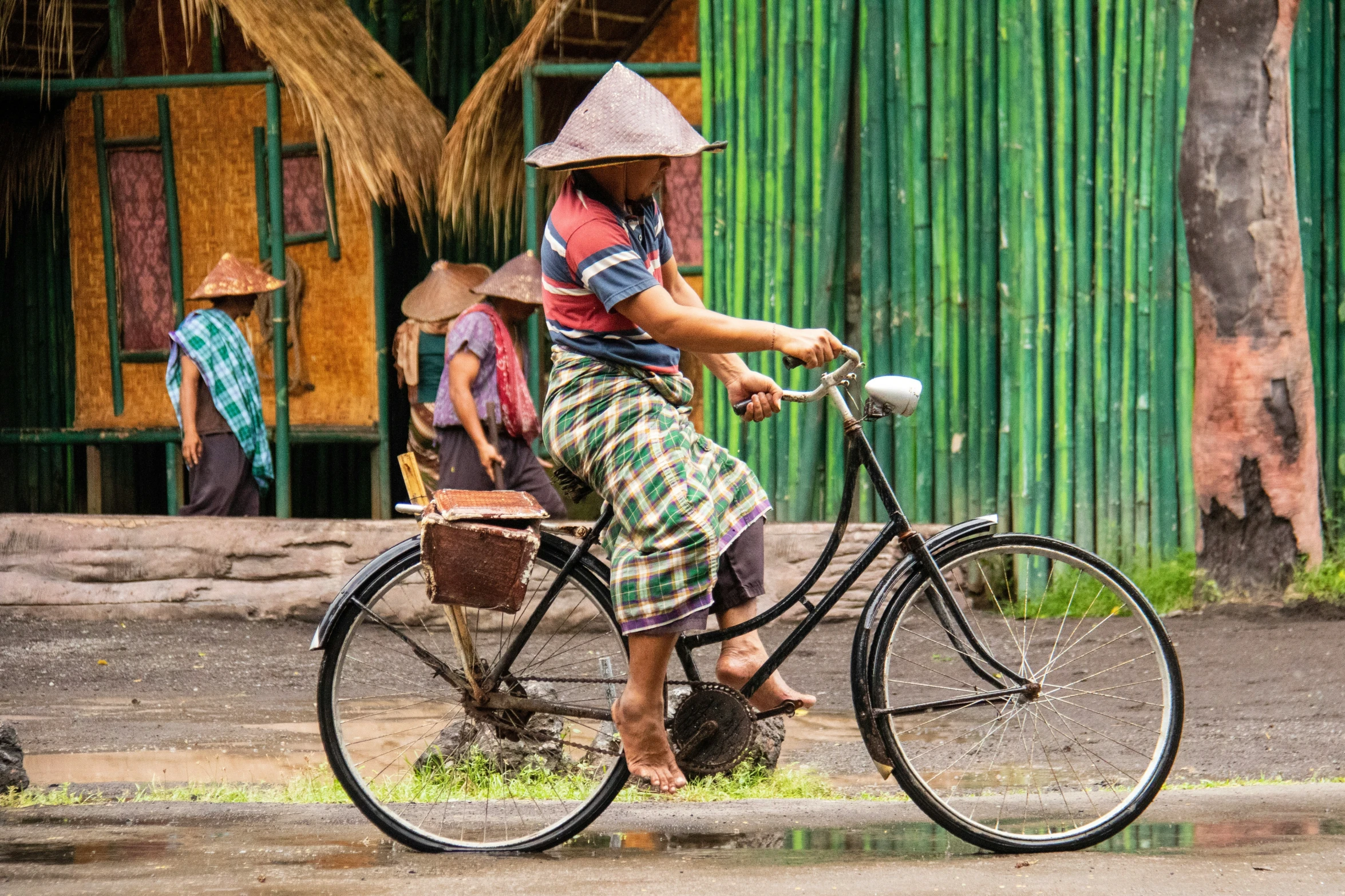 a woman riding a bike down the middle of the road