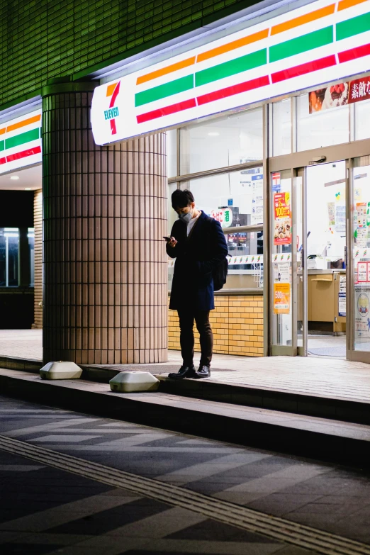 two people standing outside a business on the street