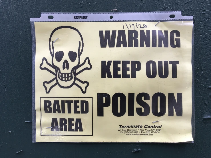 a warning sign on the side of a building