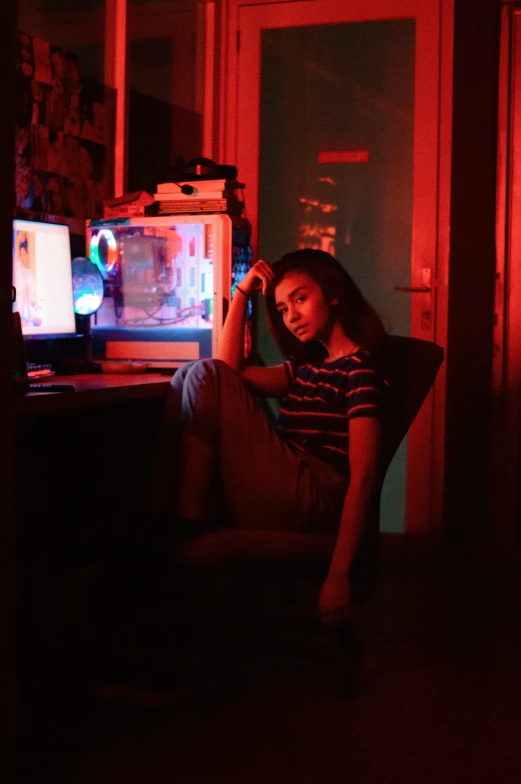 a woman sitting in a chair next to a wall