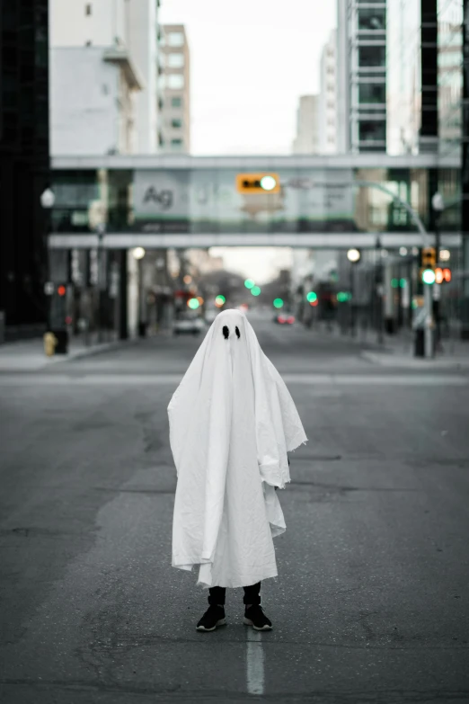 a person dressed as ghost on a city street