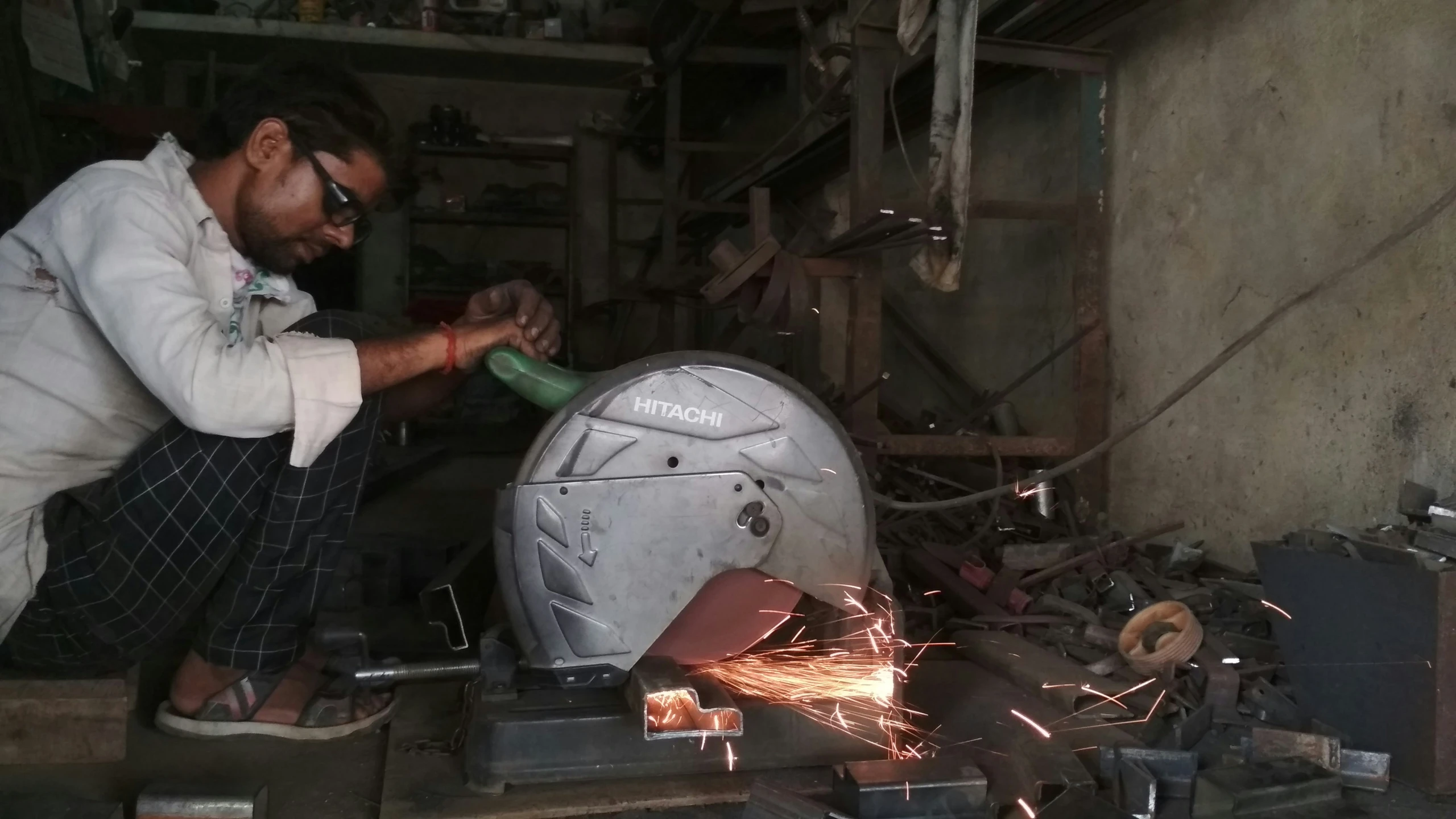 a man is welding soing with a large metal object