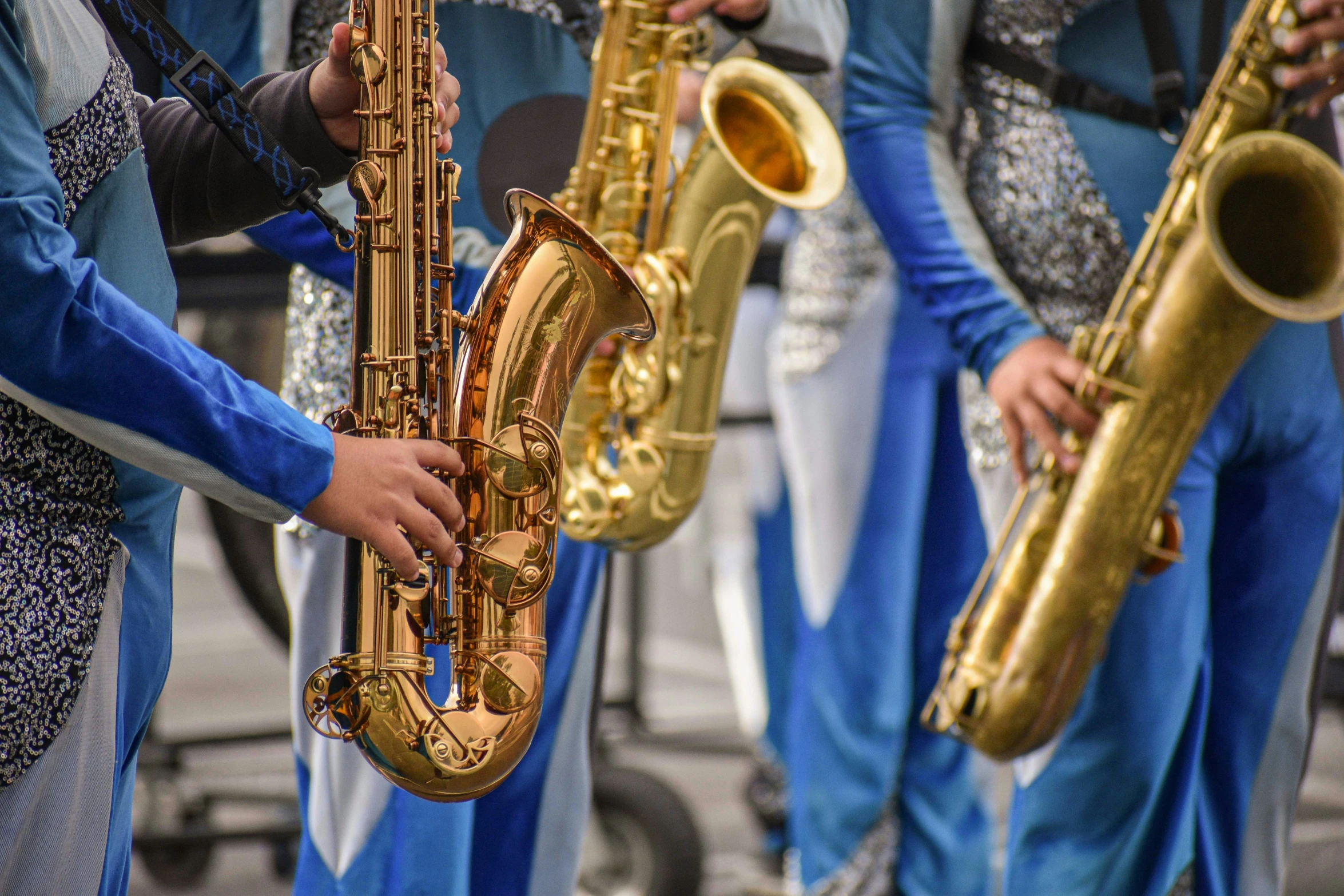 group of men standing around and playing different kinds of musical instruments