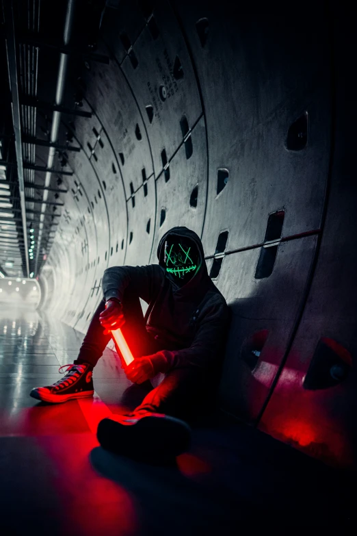 a man in black wearing a neon mask