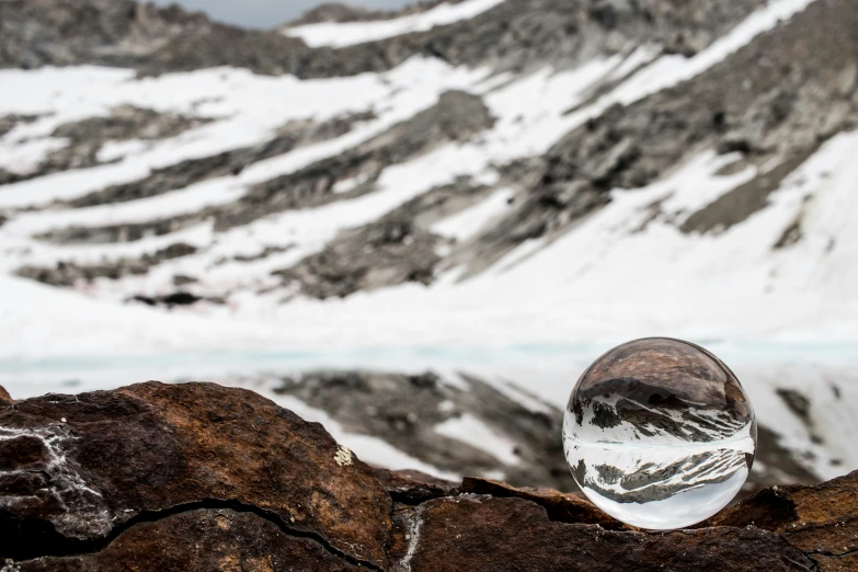 a piece of clear rock sitting in the snow