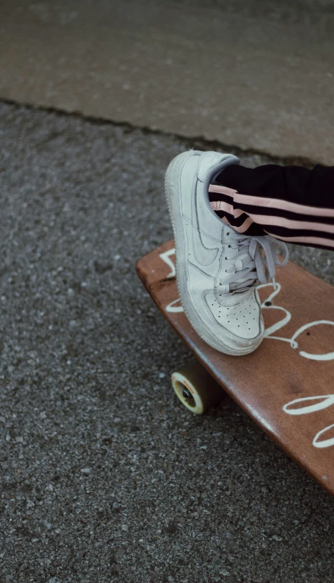 a person is standing on a skateboard while wearing nike sneakers