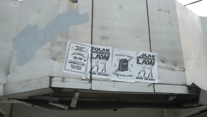 some white signs on a large white building