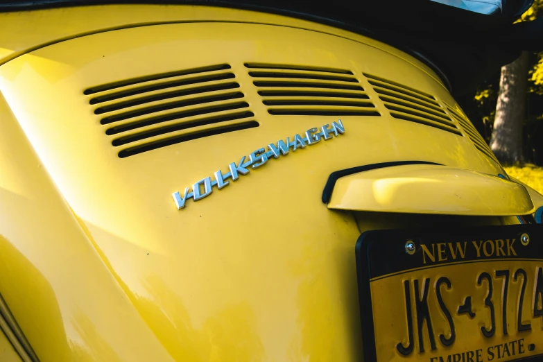 a yellow sports car with the name of the manufacturer