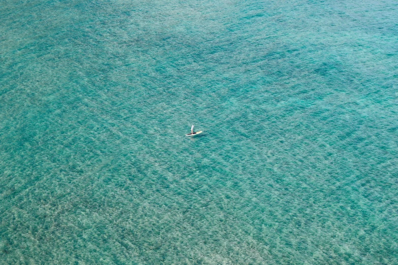 the airplane is flying low over the ocean