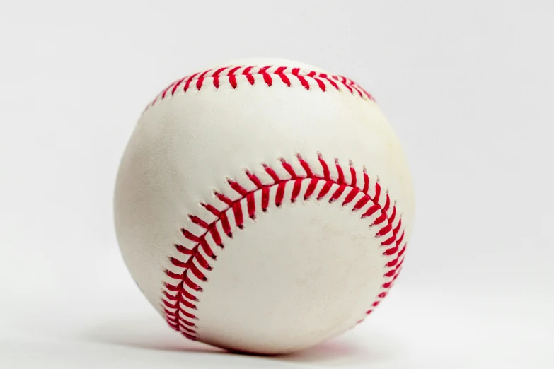 a baseball sitting on top of a white table