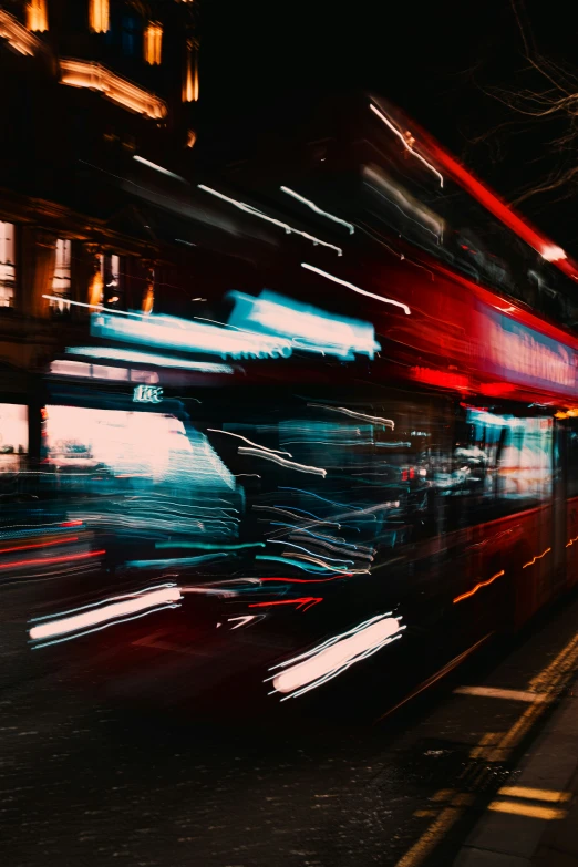 a long exposure picture of double decker buses at night