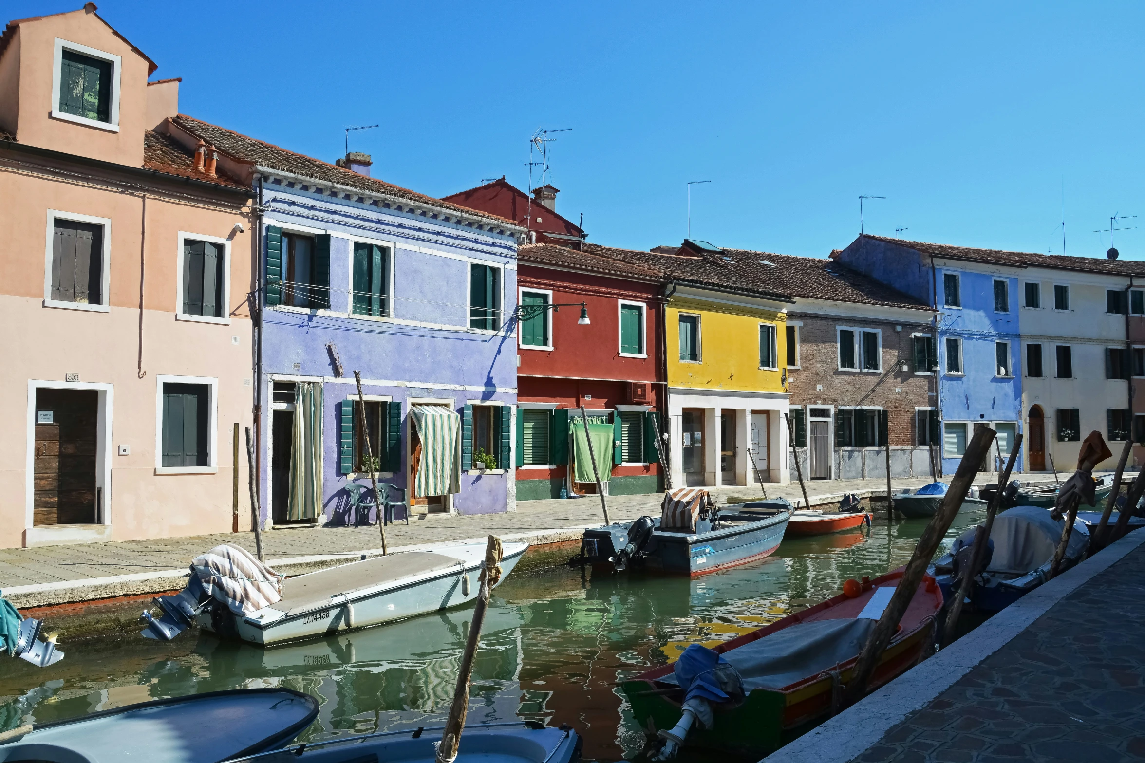 some boats docked next to a water way