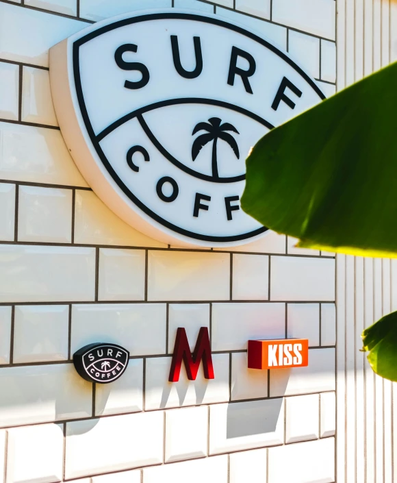 a large white brick building with the surf cafe logo above it