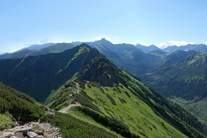 a large hill on the top of a green mountain