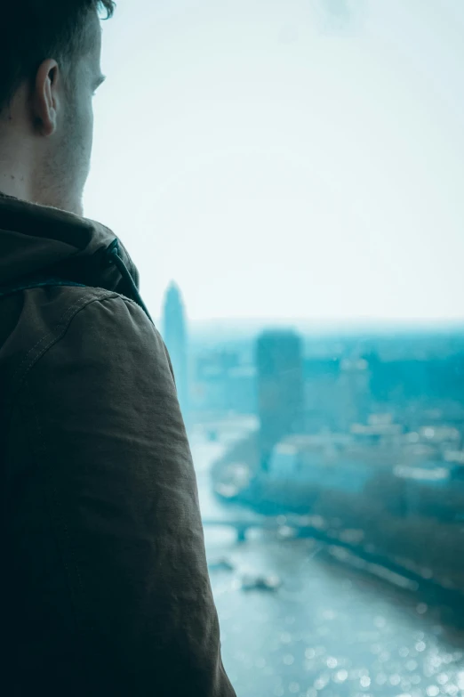 a person sitting down in front of a large window