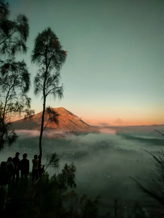 a group of people standing on top of a mountain