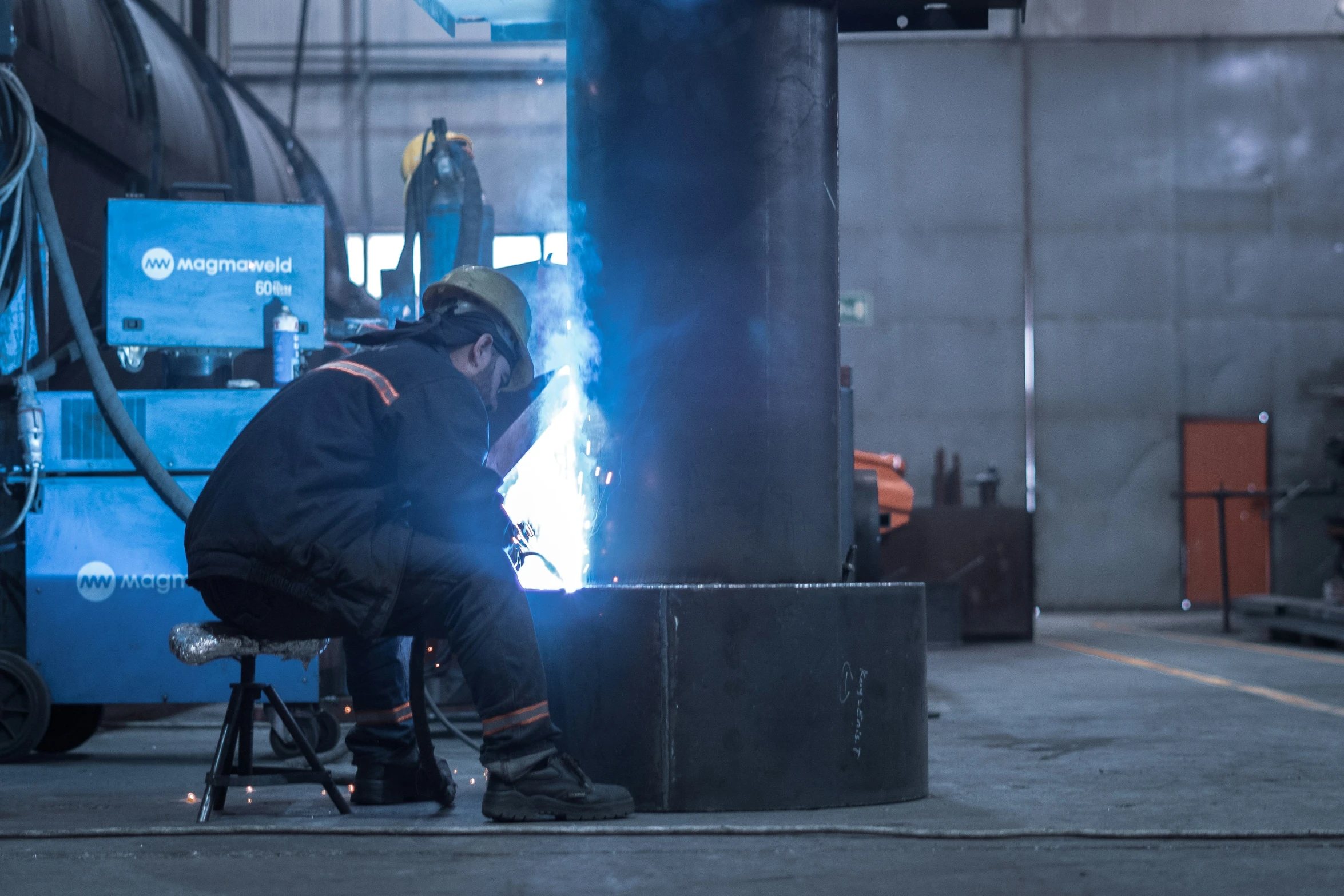 a man sitting in a chair while working on soing