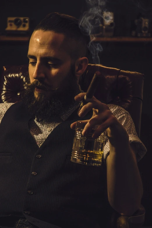 a bearded man holds a cigar and smokes a pipe