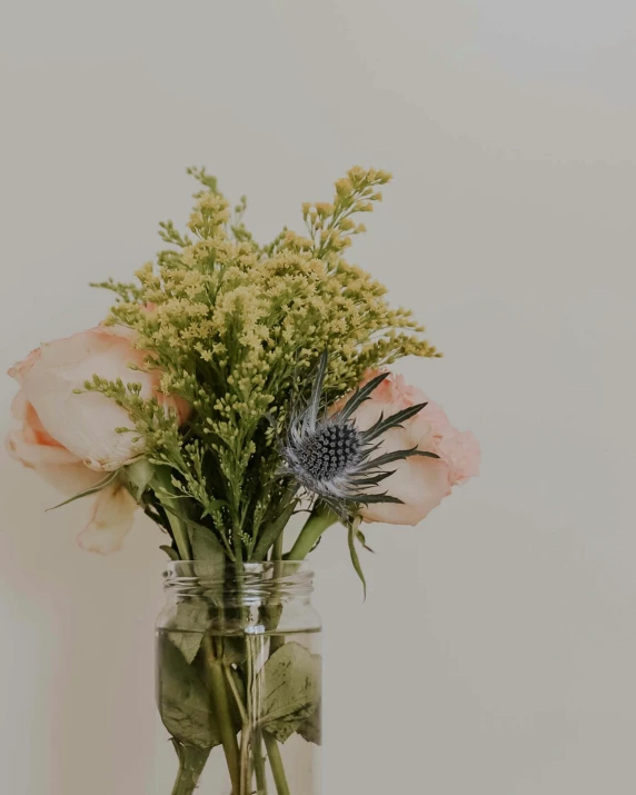 some pink flowers in a vase filled with water