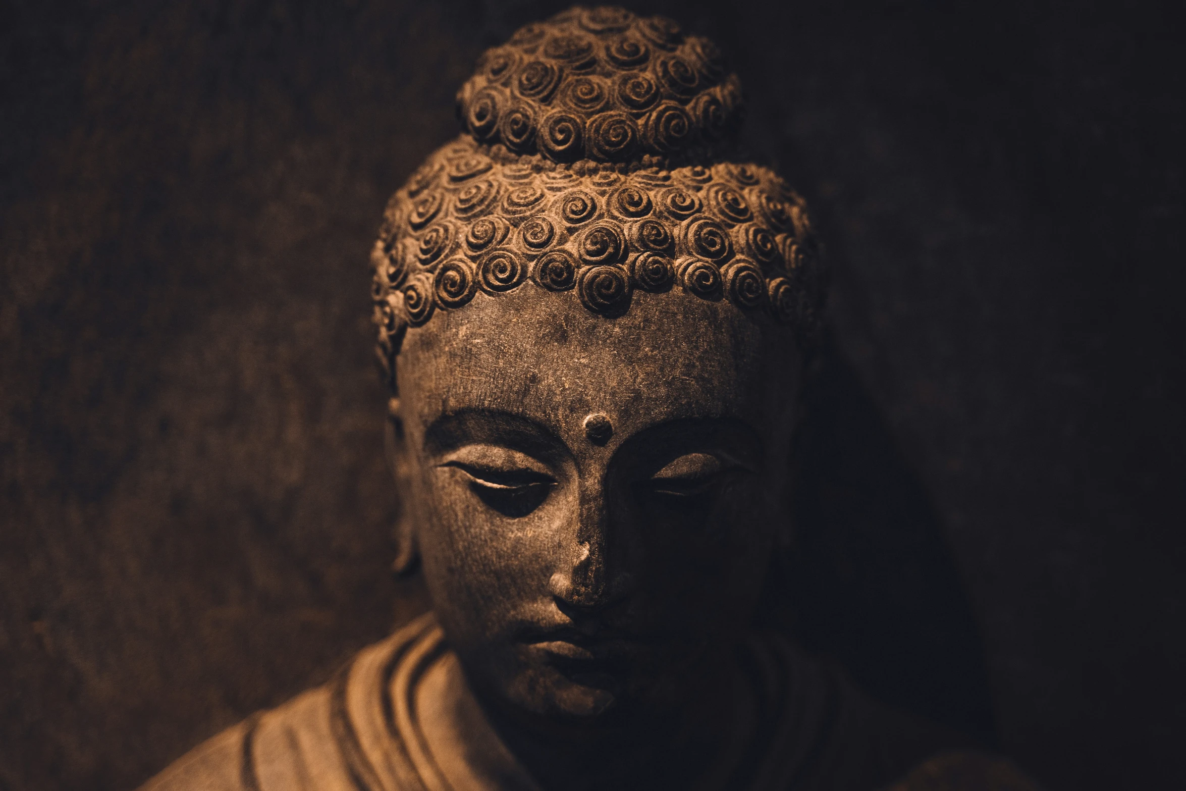 a statue with eyes closed and a buddha head