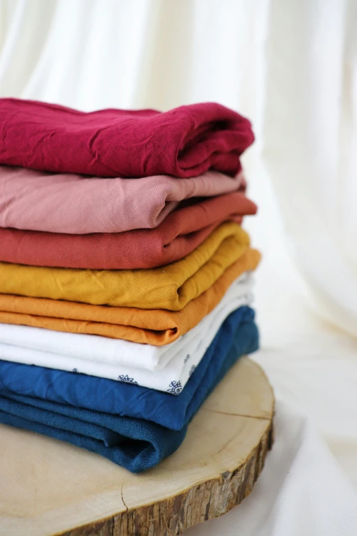 several colored fabrics stacked on top of each other
