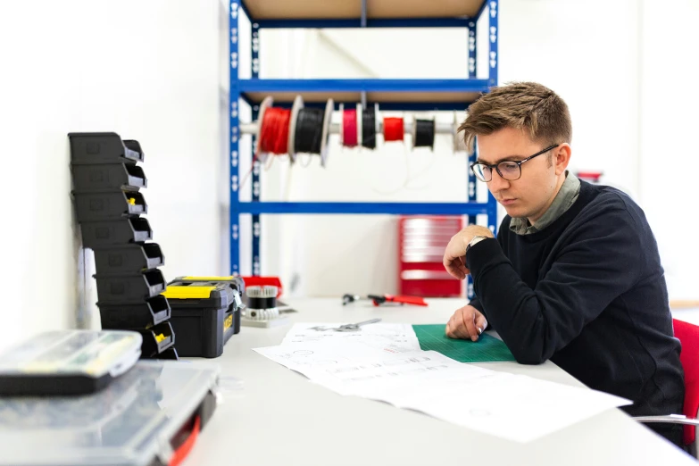 a man working in his workshop on soing that looks like it is not just making