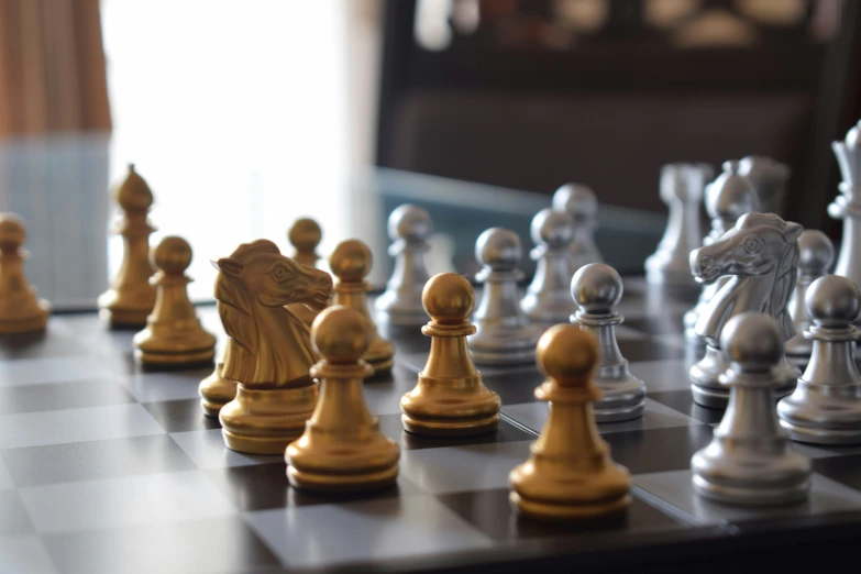 a chess board with pieces of white and gold