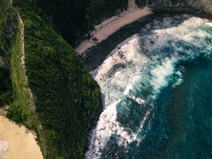 an aerial po shows water rushing toward the beach