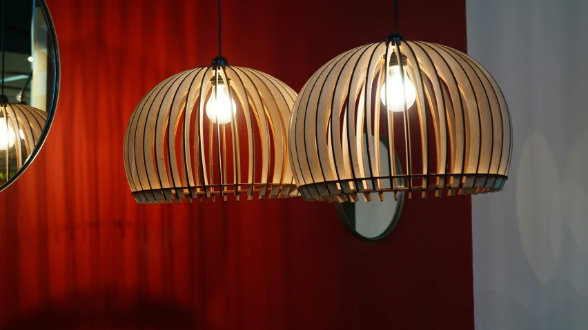 two lighting fixture hanging from red curtains