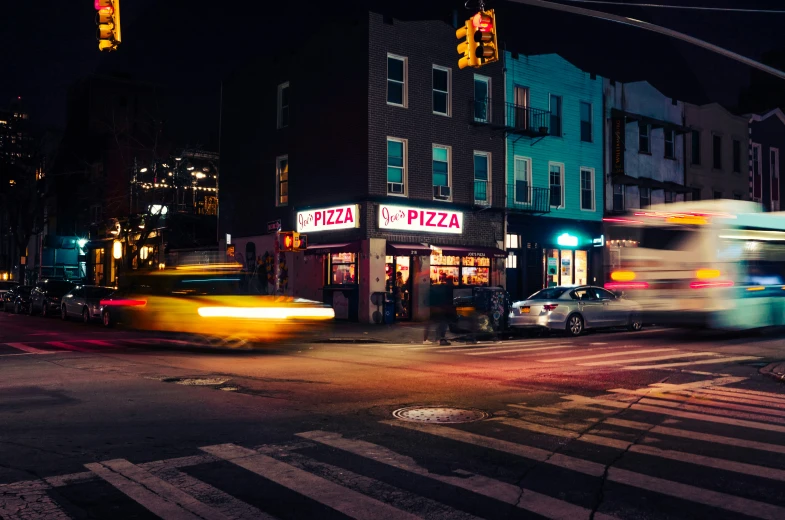 traffic passing by a cross walk in the middle of the city