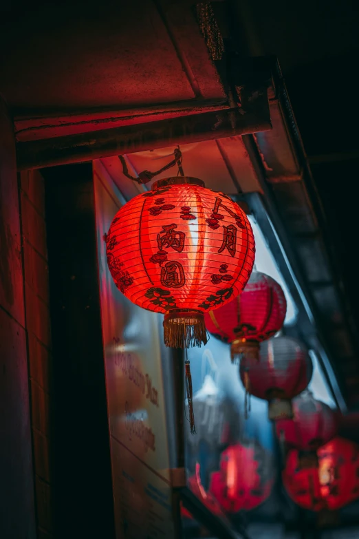 there are red lanterns that are hanging on the building