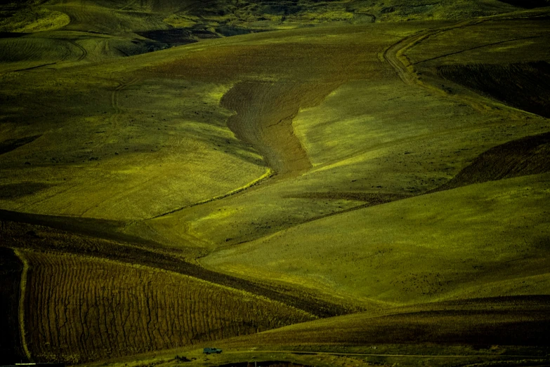 an aerial view of a farm and rolling hills
